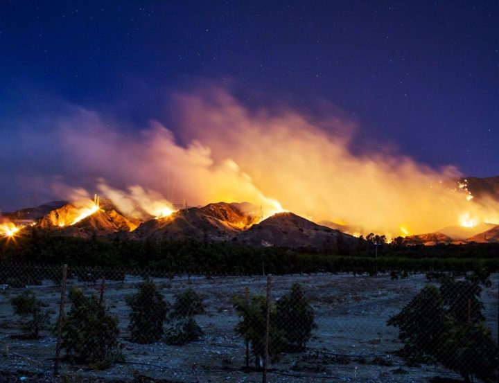 The Thomas Fire burns along a hillside near Santa Paula, California, on December 5, 2017.
More than a thousand firefighters were struggling to contain a wind-whipped brush fire in southern California on December 5 that has left at least one person dead, sent thousands fleeing, and was choking the area with thick black smoke. / AFP PHOTO / Kyle Grillot        (Photo credit should read KYLE GRILLOT/AFP/Getty Images)